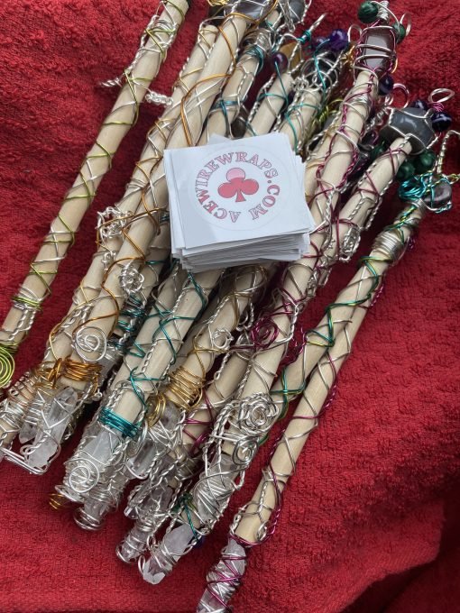 pine wand with different crystals and quartz point